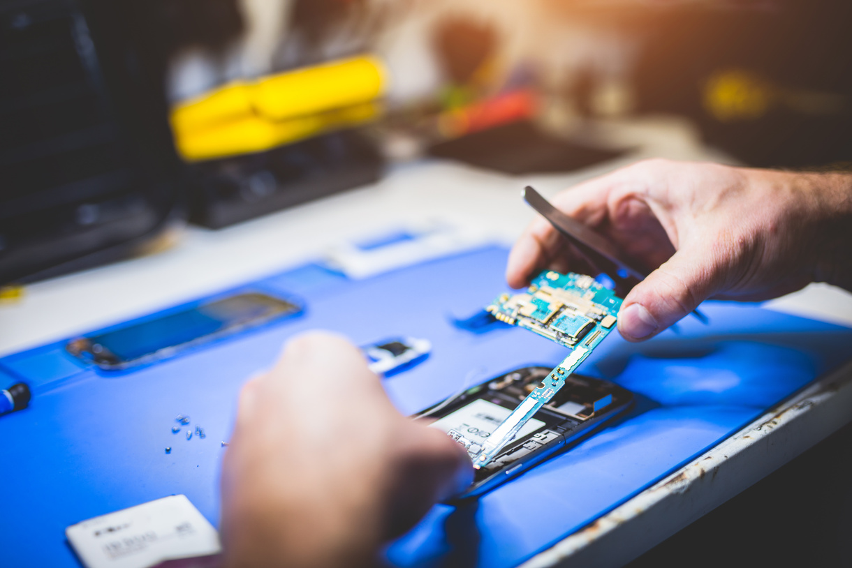 Man Fixing Broken Phone.